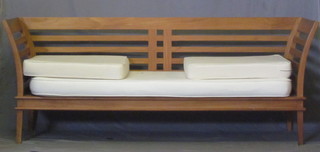 A 3 piece teak slatted suite comprising 2 seat settee and 2  matching armchairs