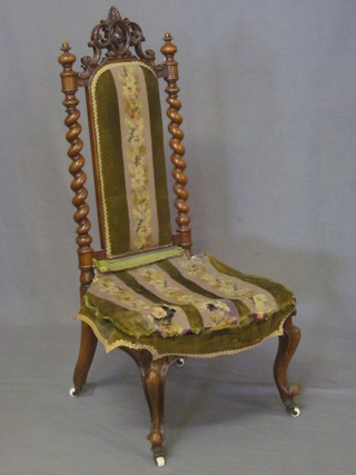A Victorian walnut nursing chair with spiral turned column to the  side, having an upholstered seat and back, requires attention,