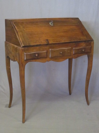 A French walnut bonheur du jour, the fall front revealing a fitted interior, the base fitted 2 short drawers, raised on cabriole  supports, warp to fall front 31"