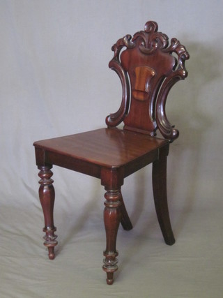 A Victorian mahogany hall chair with shield shaped back and  solid seat, raised on turned supports, f and r,