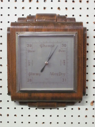 A 1950's aneroid barometer with square silvered dial, contained in a walnut case 8"