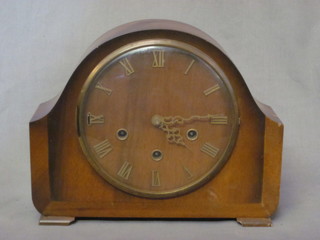 A 1950's 8 day chiming mantel clock contained in an arch shaped  case with Roman numerals