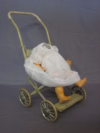 A childs metal framed push chair by Cumfifolda containing a  plastic doll, f,