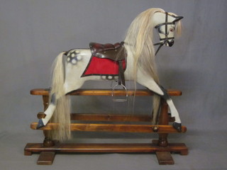 A dapple grey wooden rocking horse on stand 46"   ILLUSTRATED