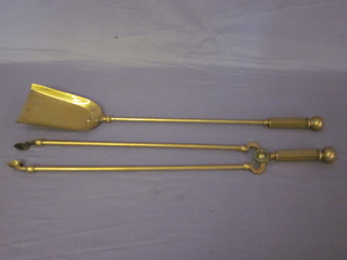 A pair of brass fire tongs and a shovel