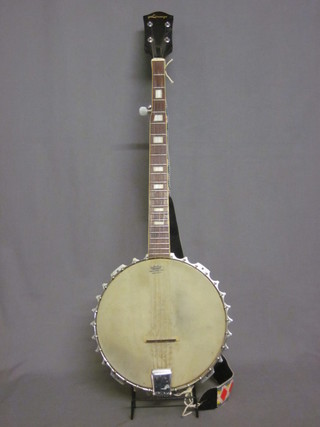 A 4 stringed banjo, marked Lorenzo, with 11 1/2" metal drum