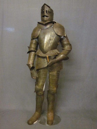 A Victorian Maximillion style engraved suit of armour complete  with visored helmet, 5' high  ILLUSTRATED