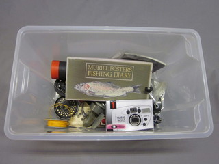 A white plastic crate containing 2 multiplying fishing reels,  various spools and a Vivitar camera