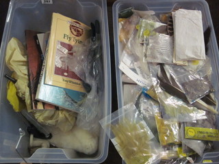 2 plastic containers containing a collection of fly tying materials