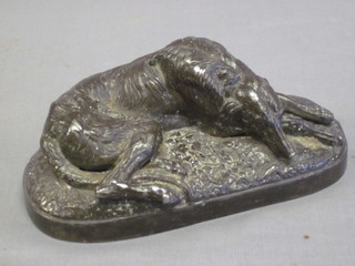 A 19th Century metal figure of a reclining hound 6"