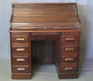 A Victorian mahogany kneehole pedestal roll top desk, the fitted interior above 1 long and 8 short drawers, 42"