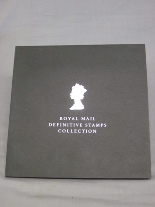 The Royal Mint Definitive stamp collection presentation pack, a  brown album of various stamps, a black loose leaf album of  various first day covers and presentation stamps and a small  collection of loose stamps