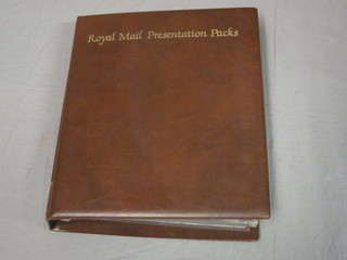 A Royal Mint red loose leaf album of various first day covers and presentation stamps