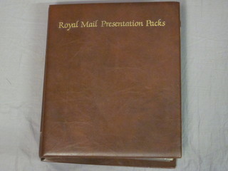 A Royal Mail brown loose leaf album of various presentation  stamps
