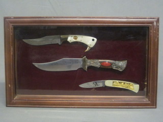 2 reproduction Bowie knives and 1 other contained in a glazed case