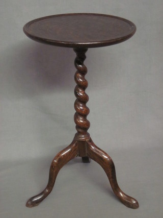 A circular oak wine table, raised on a pillar and tripod base 11"