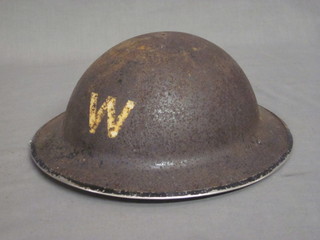 A WWII air raid warden's steel helmet, no liner,