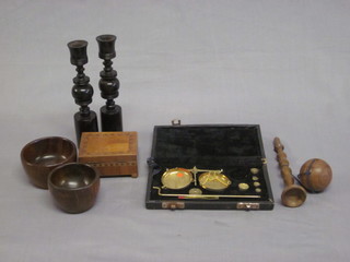 A pair of gilt metal gold scales, a pair of antique turned wooden candlesticks and a small collection of treen