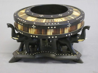 A circular ebony ashtray with porcupine quill decoration  supported by elephants 7"
