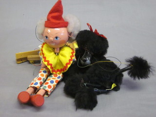 A Pelham puppet in the form of a dog and 1 other in the form of  a clown