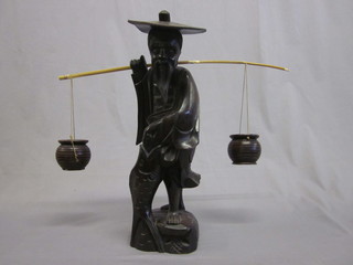 An Eastern carved wooden figure of a water carrier 17"