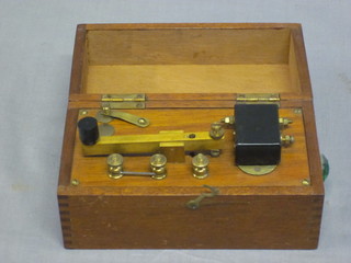 A morse key contained in a mahogany box with hinged lid 6"