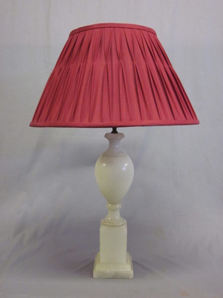 An alabaster bulbous shaped table lamp, raised on a square base 18"