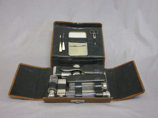 A 1930's chrome vanity set contained in a leather case