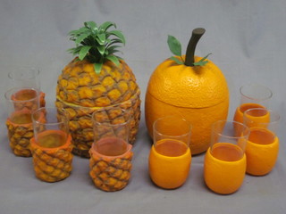 A 1960's cocktail set comprising a plastic pineapple and 3 glasses with pineapple decoration, together with a ditto orange ice pail  and 4 glasses, by Featherfoam Ltd