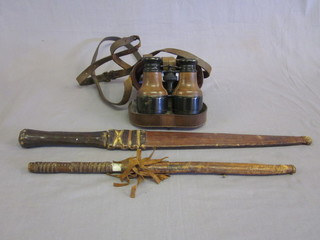 A pair of 19th Century binoculars with a laminated certificate by the Natural Physical Laboratory and 2 Eastern daggers