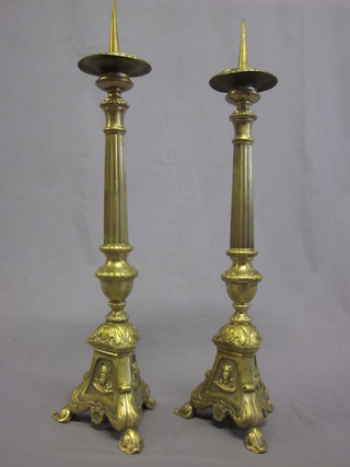 A pair of religious brass pricket candlesticks 23"