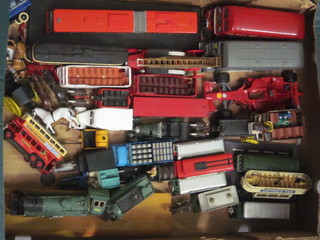 A cardboard box containing a collection of omnibus, toy cars etc