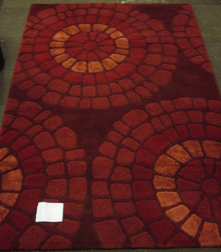 A wool red ground contemporary rug 70" x 47"