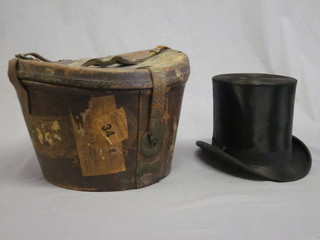 A gentleman's black silk top hat by Tree & Co, contained in a  brown leather case