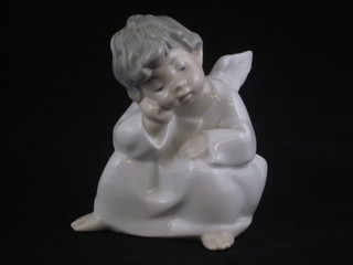 A Lladro figure of a seated Angel child 4"