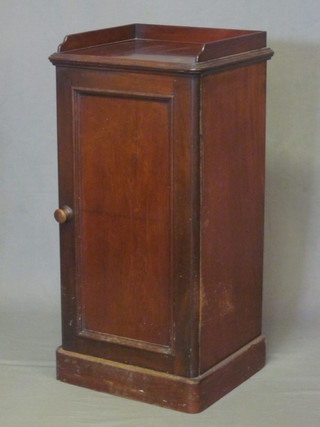 A Victorian mahogany pedestal pot cupboard with three-quarter gallery enclosed by a panelled door 16"