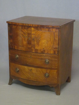 A 19th Century mahogany bow front commode with inset brown  leather surface, the base fitted a cupboard enclosed by panelled  doors, raised on bracket feet 24"
