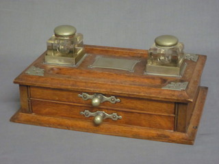 A Victorian rectangular oak standish, the top with 2 cut glass inkwells and a pen recess, the base fitted 2 drawers 14"