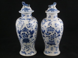 A pair of Oriental urns and covers decorated figures carrying  urns, the base with 4 character mark, 8", 1 f and r,   ILLUSTRATED