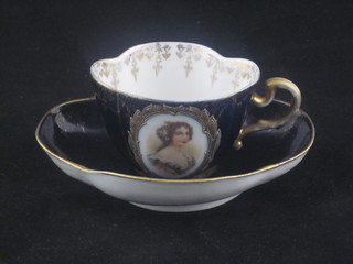 An Austrian porcelain boat shaped cabinet cup and saucer with  blue ground and panelled decoration depicting ladies