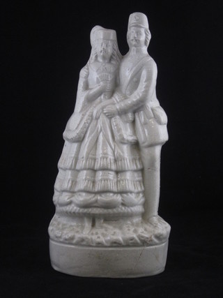A white glazed Staffordshire figure group of a soldier and lady  11", f and r,