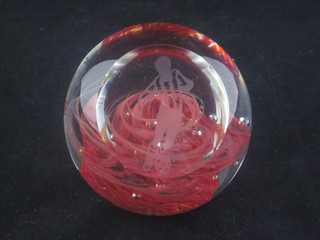 A glass paperweight decorated a footballer