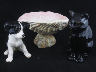 A Sylvac shell shaped dish, a Sylvac figure of a black and white seated dog and a black pottery figure of a cat