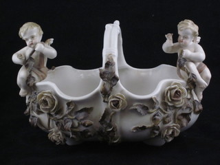 A Continental porcelain oval basket with floral encrusted and  cherub decoration, 8"