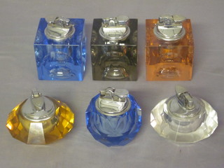 5 various table lighters contained in faceted glass bases