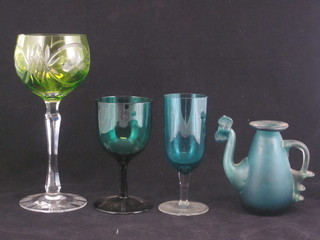 A green glass long stemmed hock glass, 10 various green glasses and a miniature glass ewer