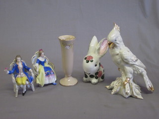 A Wemyss style figure of a seated rabbit 5", a porcelain figure of  a seated bird, 2 porcelain figures of seated lady and gentleman  and a Sadler vase