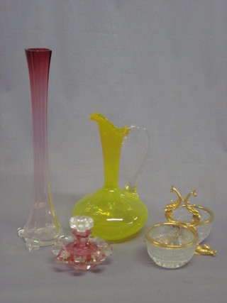 A vaseline glass ewer with clear glass handle, a circular pink  glass stub shaped scent bottle 4", a pink glass vase 16" and a cut  glass and gilt metal twin section dish