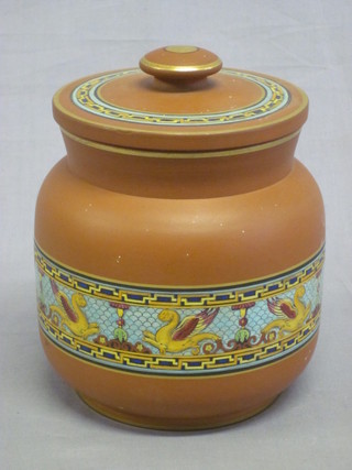 A cylindrical terracotta glazed tobacco jar with screw lid 4 1/2",  chip to inner rim,