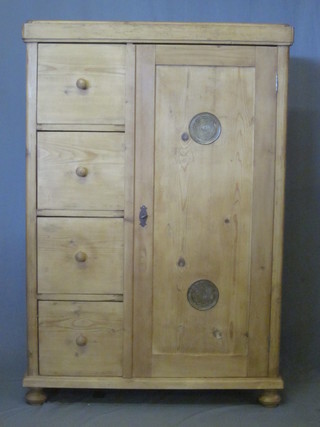 A Continental pine combination cabinet, the interior fitted shelves enclosed by a grilled door and flanked by 4 long drawers with  tore handles, raised on bun feet, 38"